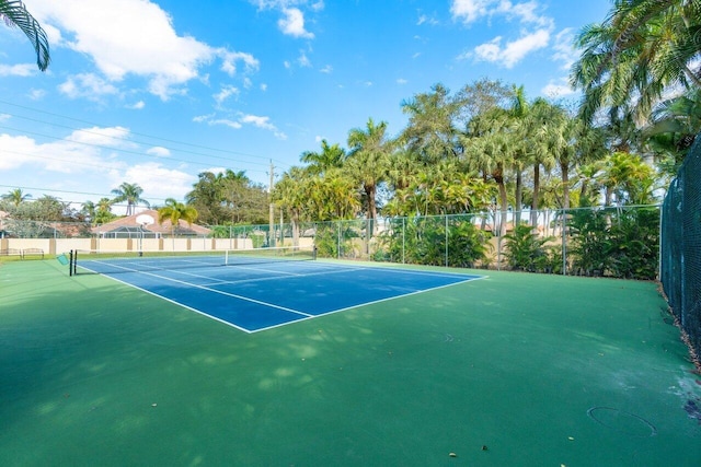 view of tennis court with fence