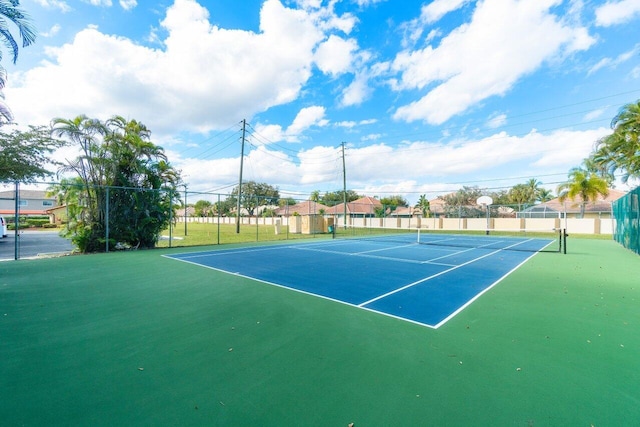 view of sport court featuring fence