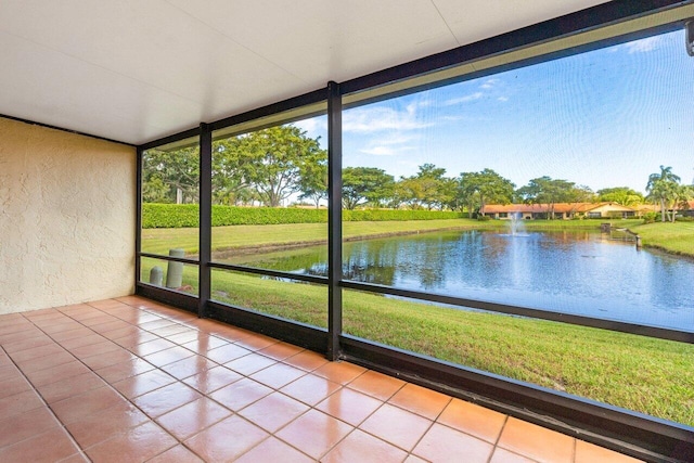 unfurnished sunroom featuring a water view