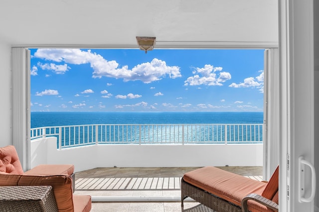 balcony featuring a water view and a beach view