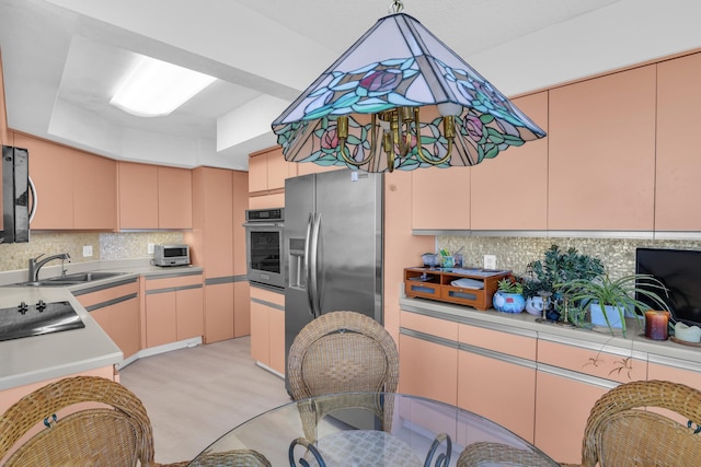 kitchen with stainless steel appliances, sink, and decorative backsplash