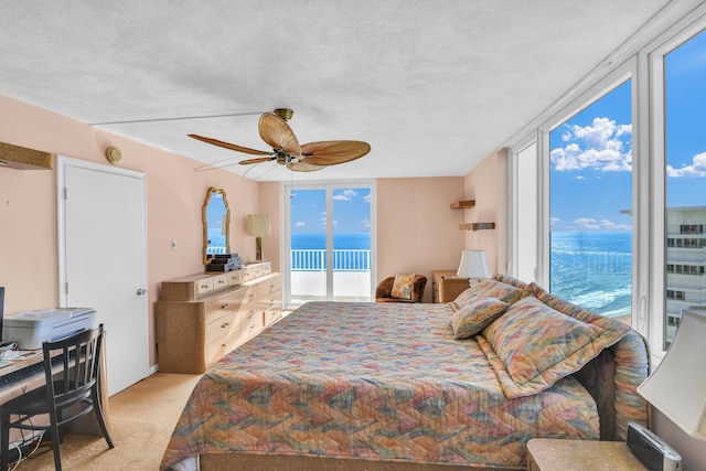 bedroom featuring access to outside, floor to ceiling windows, light colored carpet, and multiple windows