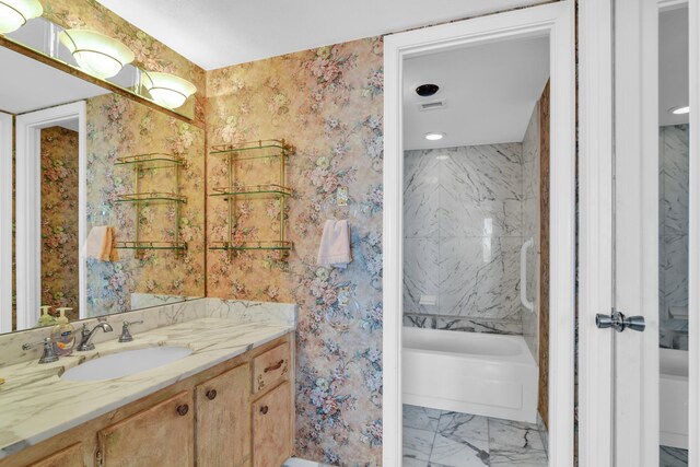 full bath with marble finish floor, shower / tub combination, wallpapered walls, and vanity