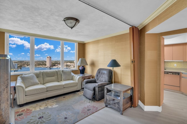 living room featuring a water view, light wood finished floors, and crown molding