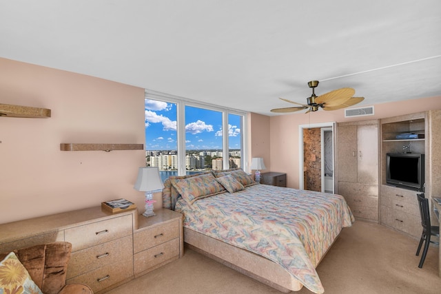 bedroom featuring ceiling fan and light carpet