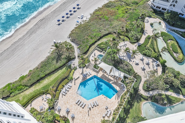 drone / aerial view featuring a water view and a beach view