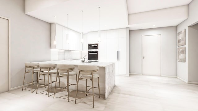 kitchen featuring modern cabinets, a breakfast bar, decorative light fixtures, white cabinetry, and a peninsula