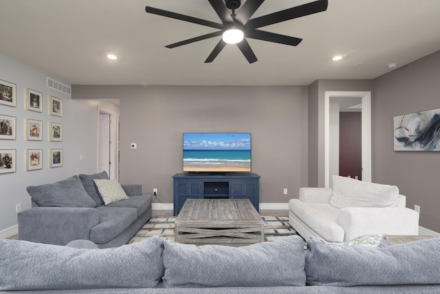 living room featuring ceiling fan and light hardwood / wood-style flooring