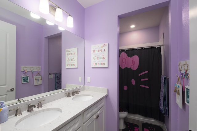 bathroom with vanity, toilet, and curtained shower