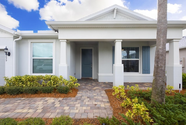 doorway to property featuring covered porch