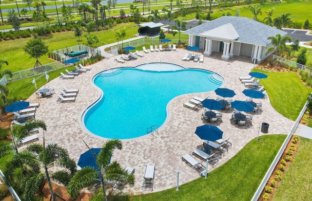 view of swimming pool featuring a yard and a patio area