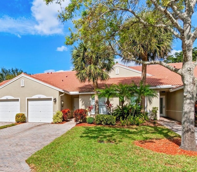 view of front of home with a garage and a front lawn