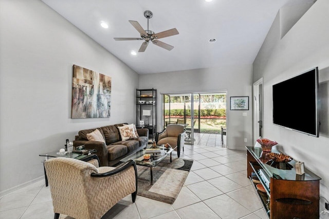 living room featuring lofted ceiling, ceiling fan, and light tile patterned flooring