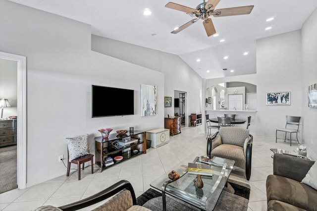 living room featuring light tile patterned floors, high vaulted ceiling, and ceiling fan