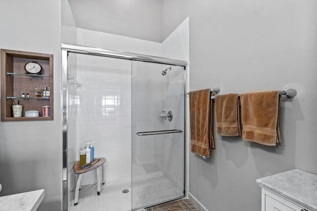 bathroom with walk in shower and vanity