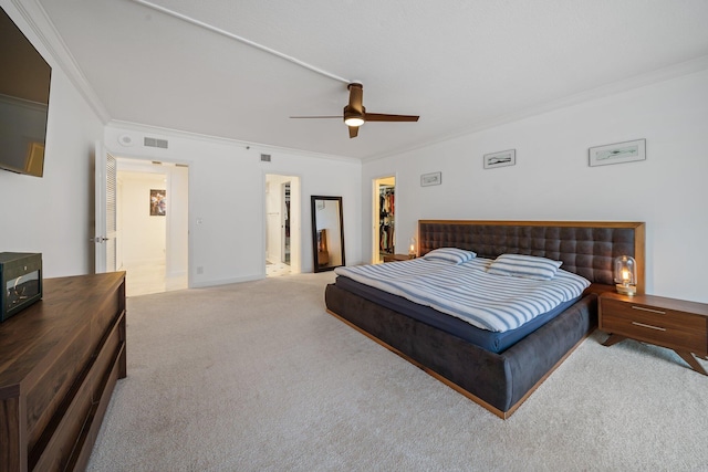 bedroom with a spacious closet, ceiling fan, crown molding, light carpet, and a closet