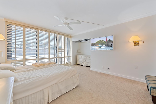 carpeted bedroom featuring ornamental molding and ceiling fan