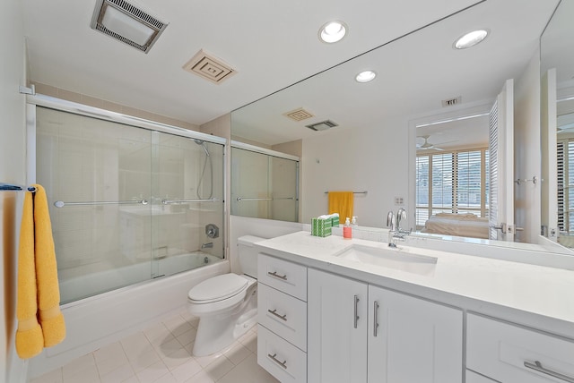 full bathroom with vanity, tile patterned floors, combined bath / shower with glass door, and toilet