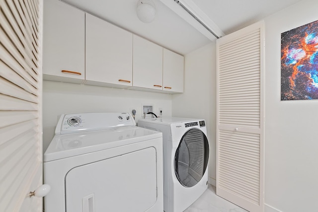 laundry area with cabinets and washer and clothes dryer