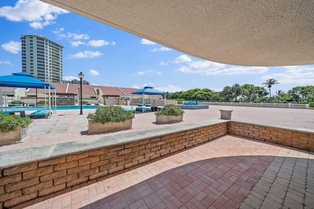 view of patio with a gazebo and a community pool