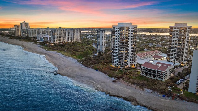 birds eye view of property with a water view and a view of the beach