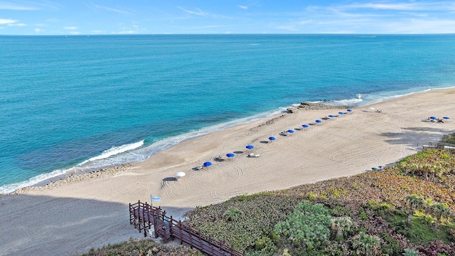 aerial view with a water view and a view of the beach