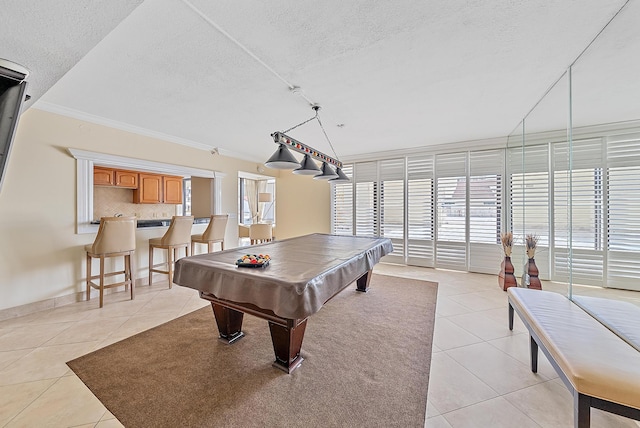 game room featuring crown molding, light tile patterned floors, pool table, and a textured ceiling