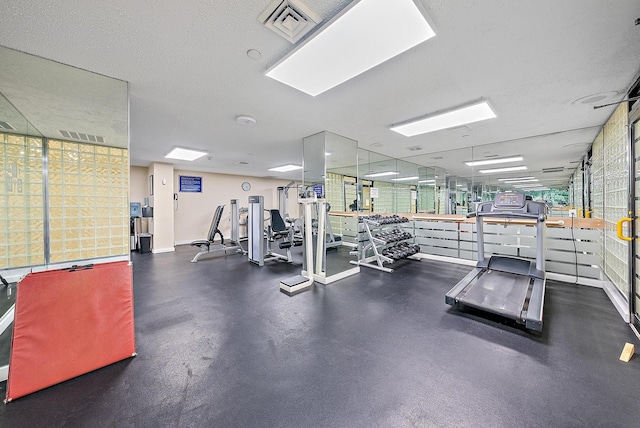 exercise room featuring a textured ceiling