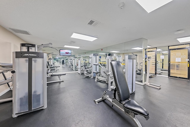 workout area with a textured ceiling