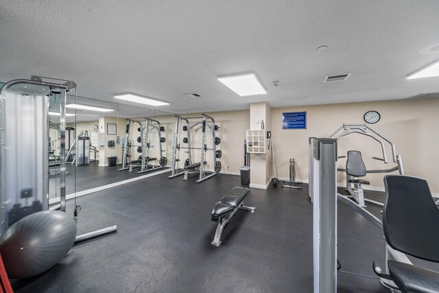 exercise room featuring a textured ceiling