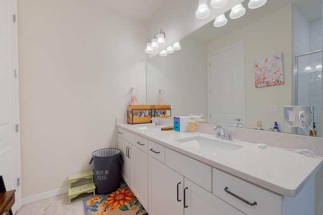 bathroom featuring a shower with door, vanity, and tile patterned floors