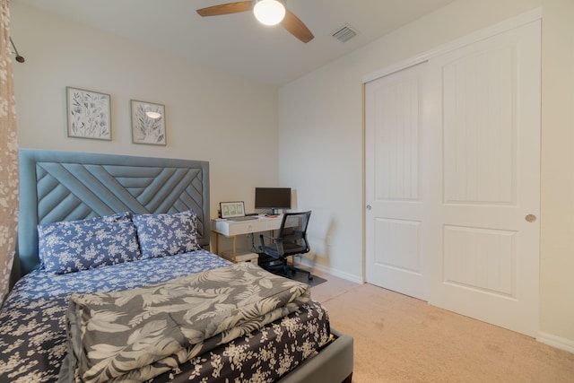 bedroom with ceiling fan, carpet floors, and a closet