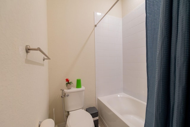 bathroom featuring shower / bath combo and toilet