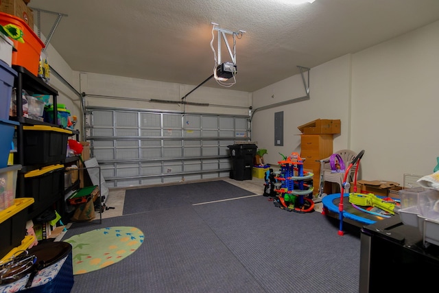 garage with a garage door opener and electric panel