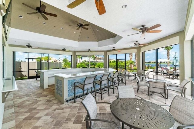 view of patio featuring ceiling fan and exterior bar