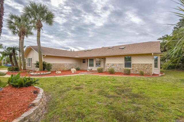 rear view of property with a lawn