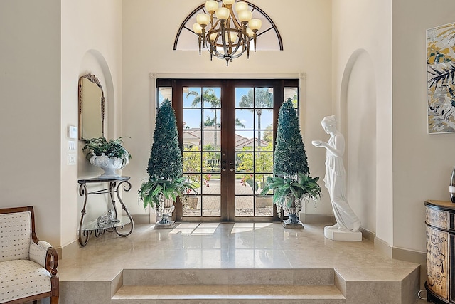 entrance foyer with an inviting chandelier and french doors