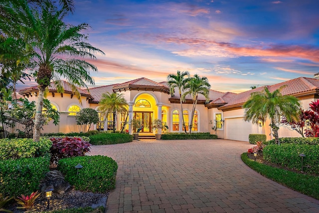 mediterranean / spanish house featuring a garage