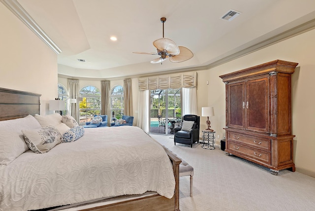 carpeted bedroom with access to outside, ceiling fan, and a tray ceiling