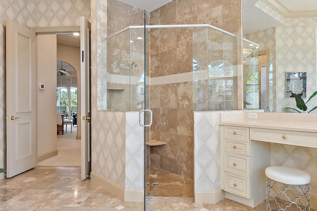 bathroom featuring crown molding, a shower with door, and ceiling fan