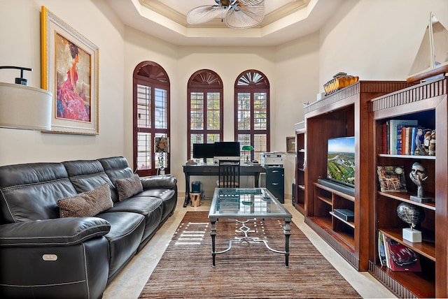 office featuring a tray ceiling, ornamental molding, and ceiling fan