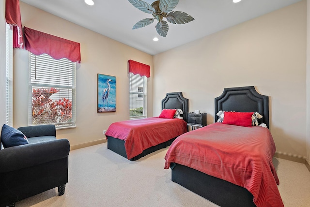 bedroom featuring multiple windows, ceiling fan, and carpet flooring