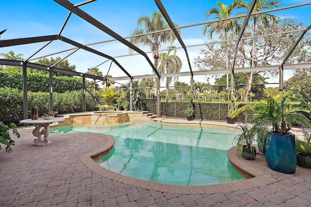 view of swimming pool featuring a lanai, a patio area, and an in ground hot tub