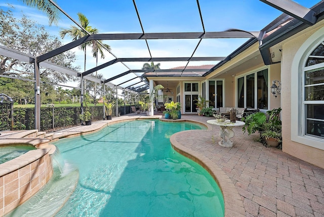 view of swimming pool featuring a patio, a lanai, and an in ground hot tub