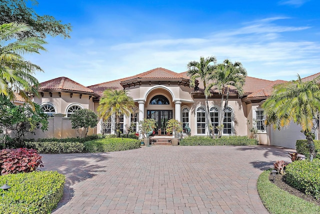 mediterranean / spanish-style home featuring french doors and a garage