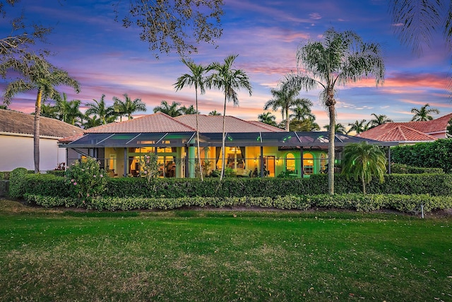 back house at dusk with a yard