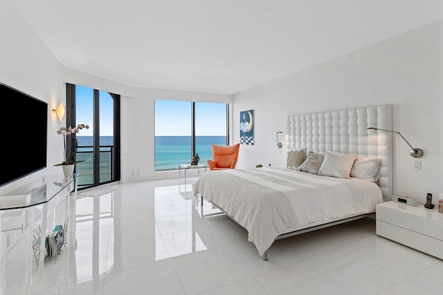 bedroom with access to exterior, light tile patterned flooring, and a water view