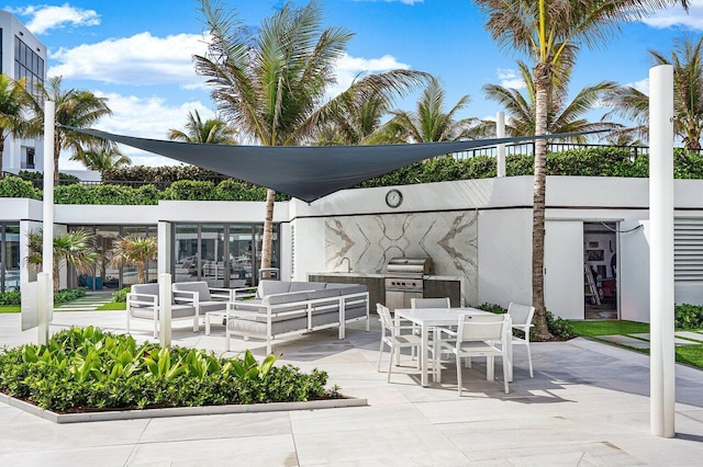 view of patio / terrace featuring area for grilling, outdoor dining space, a sink, a grill, and an outdoor hangout area