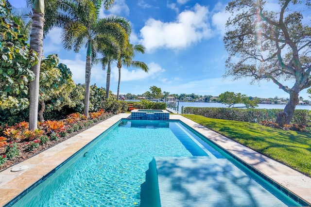 view of pool with an in ground hot tub, a water view, and a yard