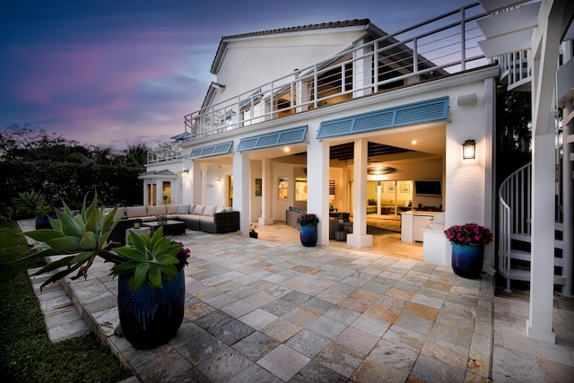 view of patio with a balcony and outdoor lounge area